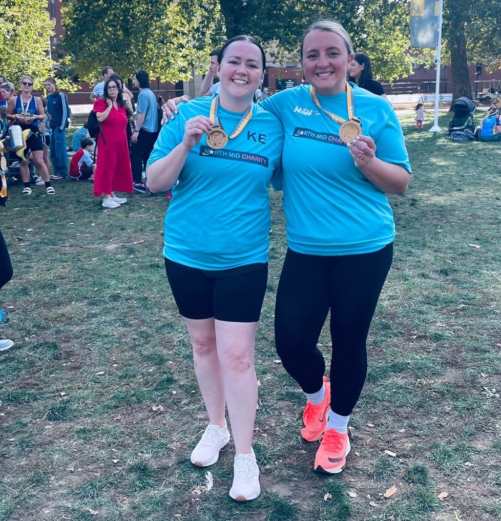 Two runners with their medals