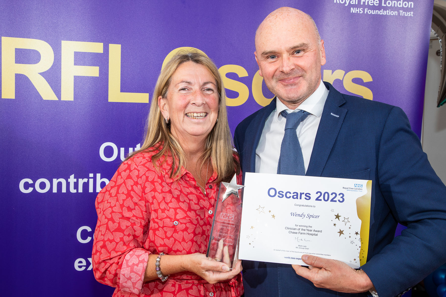 Wendy Spicer posing with Alan McGlennan and her certificate 