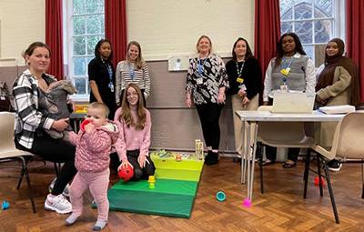 Universal Therapies team with a mother and baby