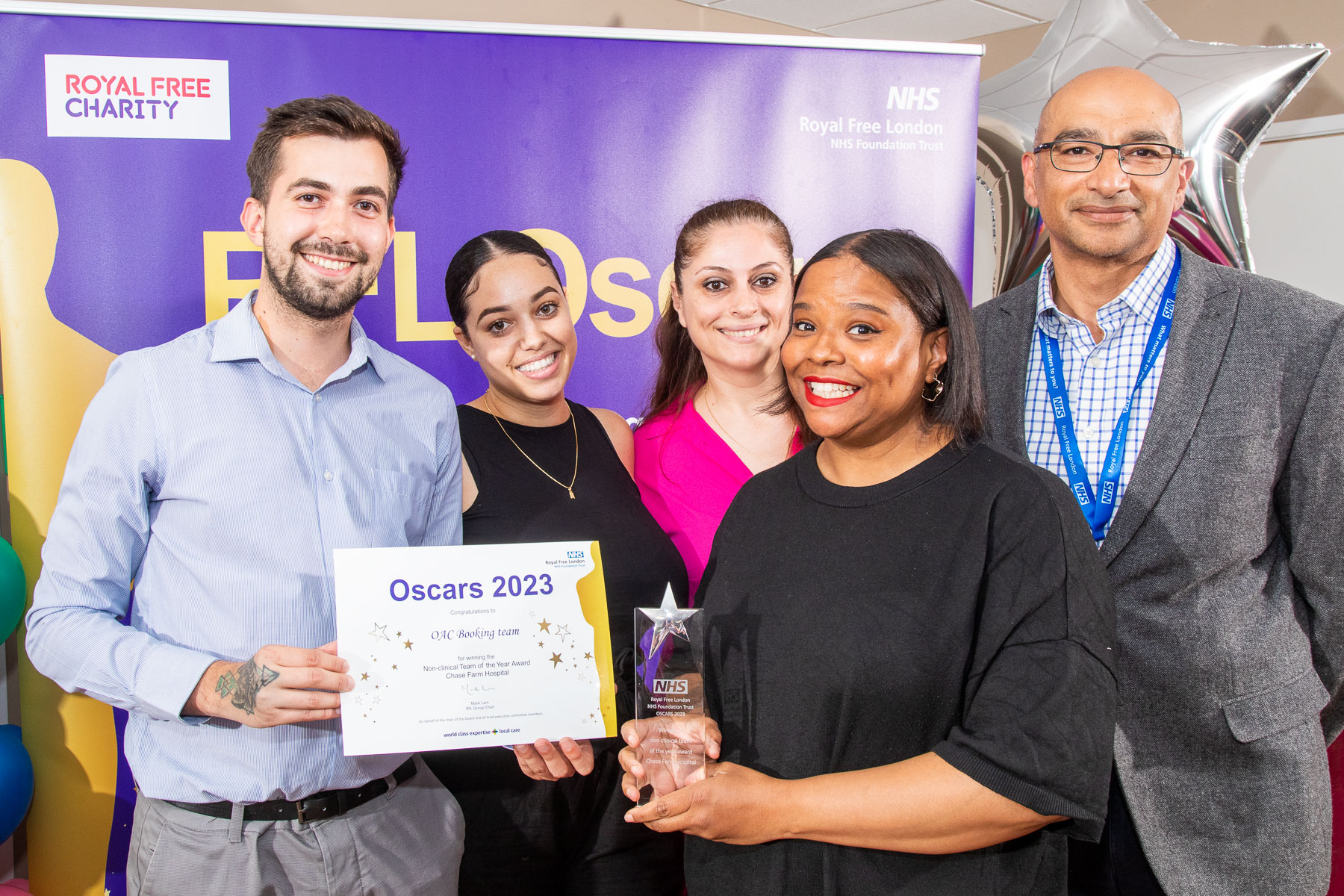 OAC booking team posing with their certificate alongside Ash Saini