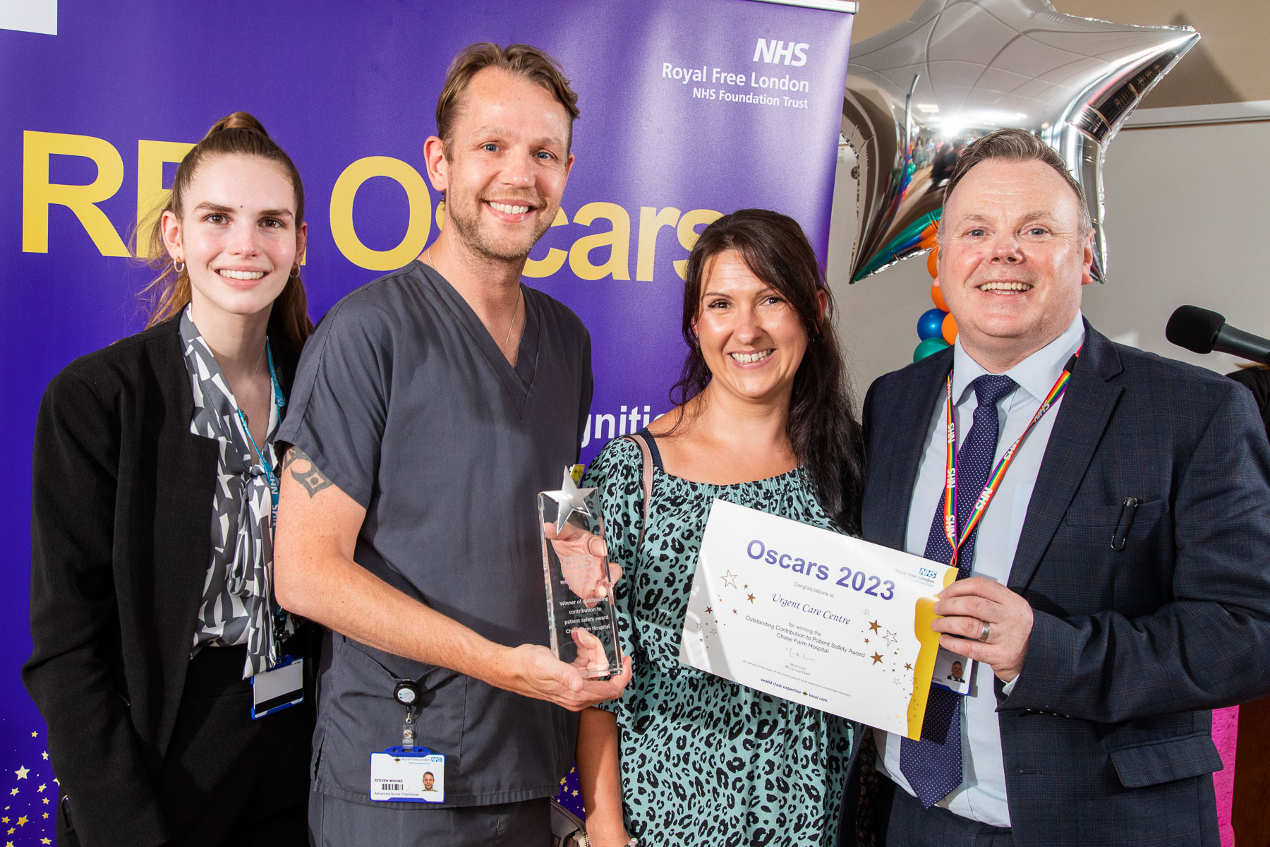 Urgent care centre team posing with their award and certificate alongside Lenny Byrne