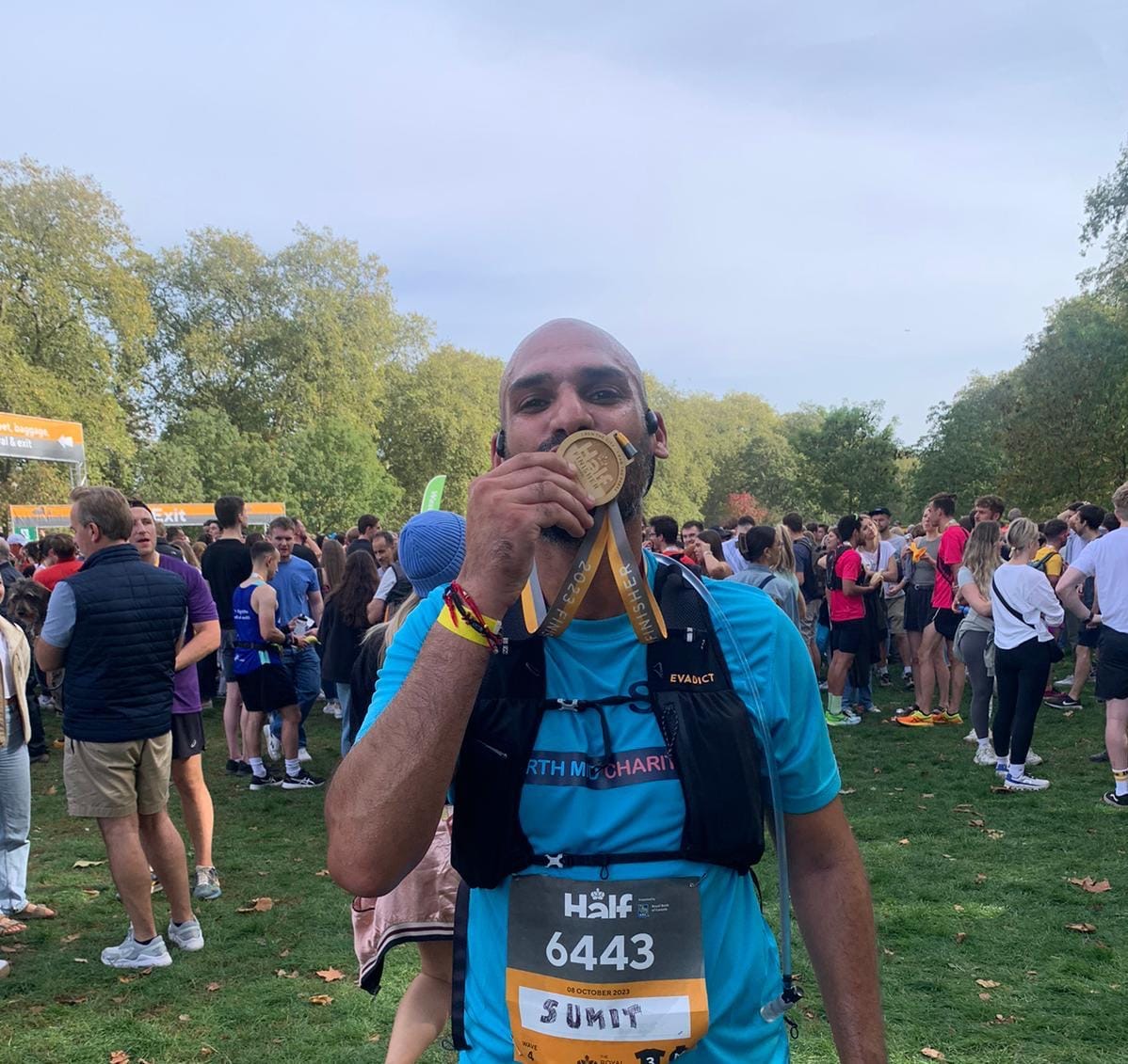 Runner kissing medal